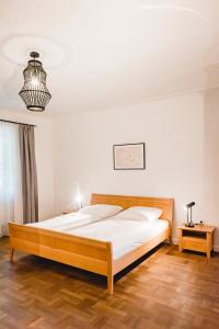 a bedroom with a large bed in a room at Das Gästehaus in Sankt Veit am Vogau