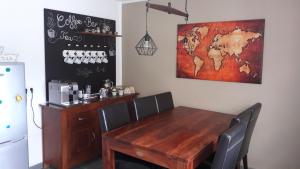 a dining room with a wooden table and a map on the wall at Haus Steffi in Müllheim