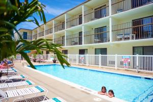 a swimming pool in front of a hotel at The Bay Resort in Dewey Beach