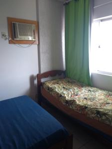 a small room with two beds and a window at Cond. Golden Thermas Residence - Shapphire Tower in Caldas Novas