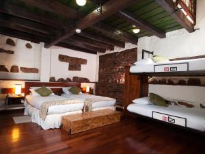 Postel nebo postele na pokoji v ubytování Hotel Muisca + 37 fotografií