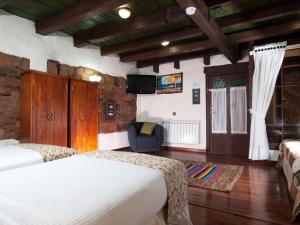 Postel nebo postele na pokoji v ubytování Hotel Muisca