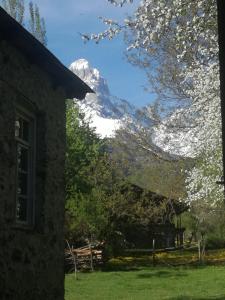 a view of a snow covered mountain from a house at Dali Kaldanis Guest House in Becho in Mestia