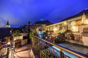 a balcony of a hotel at night with a swimming pool at Hotel Muisca in Bogotá