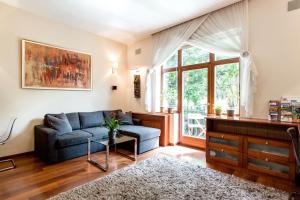 a living room with a couch and a window at CityPark Design Flat in Budapest