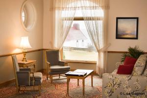 a living room filled with furniture and a window at Hotel Tadoussac in Tadoussac