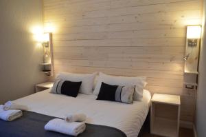a bedroom with a large bed with two towels on it at Hostal Boutique Puerta Roja in Punta Arenas +76 photos