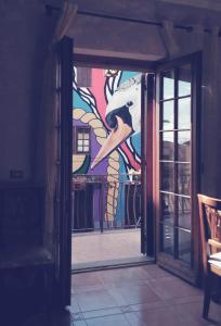a glass door with a painting of a horse at Wanderlust Sant'Angelo il paese delle Fiabe in Roccalvecce