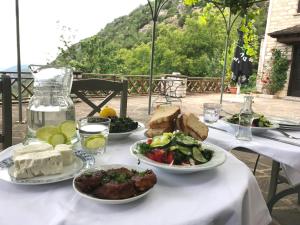 a white table with plates of food on it at Mousafir Ontas in Kapesovo +106 photos