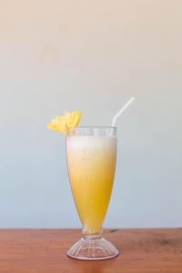 a glass of orange juice sitting on a table at Mamaras Guest House in Nusa Penida +80 photos
