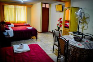 a room with a bed and a table with a tableablish at Hospedaje San Pedro Tacna in Tacna