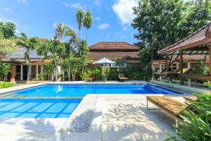 an image of a swimming pool in a villa at Ayu Lili Garden Hotel Kuta in Kuta