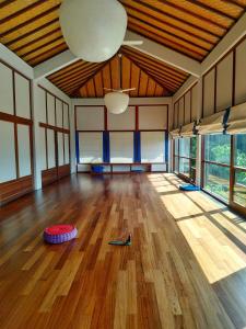 a large room with a wooden floor and a ceiling at Suarapura Resort & Spa in Tegalalang