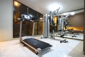 a fitness room with a gym with a treadmill at Rasuna Mansion in Jakarta