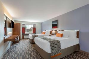 Habitación de hotel con 2 camas y TV en Microtel Inn & Suites by Wyndham Niagara Falls, en Niagara Falls