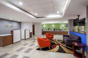 a lobby of a dental office with chairs and a counter at Baymont by Wyndham McDonough in McDonough