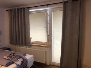 a bedroom with a window with blinds on it at Julia in Kaprun