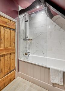 
a bathroom with a shower, sink, and tub at The Greyhound Inn in Wantage
