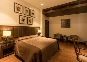 a bedroom with a bed and a table and chairs at Park Suites in Kolkata