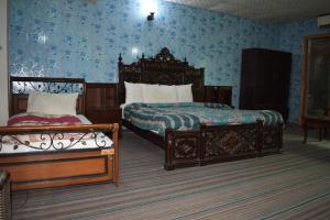 伊斯蘭堡的住宿－Tulip guesthouse，一间卧室设有两张床,拥有蓝色的墙壁。