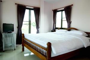 Postel nebo postele na pokoji v ubytování Loy Manee House