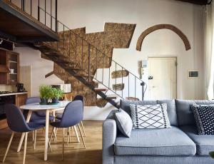 ein Wohnzimmer mit einem blauen Sofa und einem Tisch in der Unterkunft Great Apts Few Steps to The Duomo in Florenz