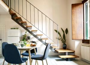 a dining room with a table and a staircase at Great Apts Few Steps to The Duomo in Florence
