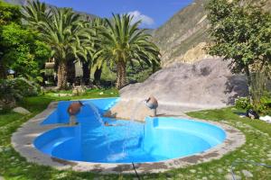 a man standing in front of a pool of water at Paraiso Las Palmeras Lodge in Cabanaconde