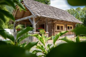 a log cabin with a porch and flowers on it at Camping Danica Cottage Stan in Bohinj