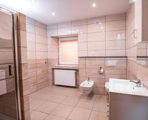 a bathroom with a sink and a toilet at Apartamenty ZYGFRYD 28C 3 6 in Bystrzyca Kłodzka