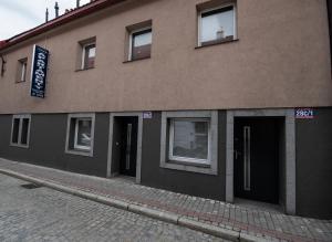 a building with doors and windows on a street at Apartamenty ZYGFRYD 28C/3/3 in Bystrzyca Kłodzka