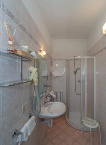 a bathroom with a shower and a sink at Hotel Mariani in Lido di Camaiore