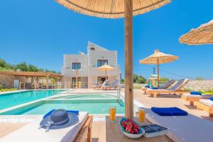 a villa with a swimming pool and a resort at Ivoni Villa, an Iconic Summer Retreat, By ThinkVilla in Perama