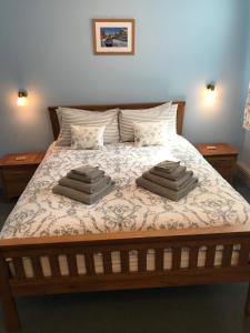 a bedroom with a bed with two pillows on it at Ashley Croft in Skipton