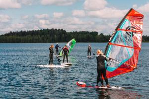 a group of people on surfboards in the water at Purjemaja in Otepää