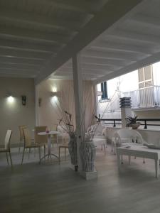 a restaurant with tables and chairs and a large window at Dream & Relax in Vieste