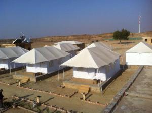 a group of tents in a field with a sky background at Savi Camps Jaisalmer in Sām
