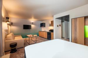 a living room with a couch and a table at ibis Styles Paris Meteor Avenue d'Italie in Paris