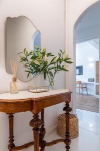 a mirror on top of a wooden table in a room at Upper Hydra in Hydra