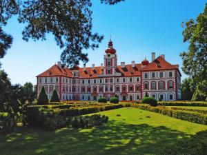 a large building with a red roof at Chalupa pod zámkem in Mnichovo Hradiště