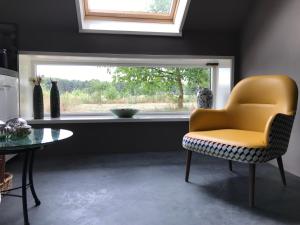 a living room filled with furniture and a window at Op 't Oorbeck in Enschede