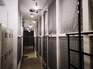 a hallway with a bunch of stalls in a building at Sunset Homestay - Backpacker Hostel Self Checkin in Kuching
