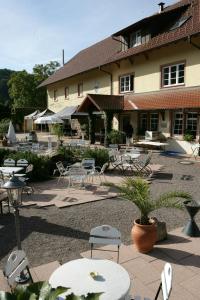 a patio with tables and chairs in front of a building at Wein Lodge Durbach - Josephsberg in Durbach