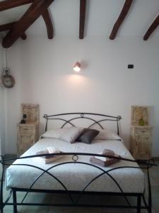 a bedroom with a bed in a room with wooden ceilings at Entula 'E Mari Bed&Brakfast in Tortolì