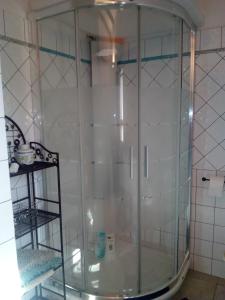 a glass shower in a corner of a bathroom at Entula 'E Mari Bed&Brakfast in Tortolì