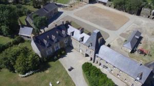 an aerial view of a large building with a courtyard at Domaine du Manoir de Vains in Vains