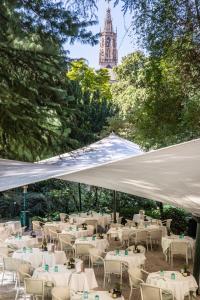 a group of tables and chairs under a white tent at Parkhotel Laurin in Bolzano