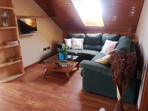 a living room with a blue couch and a table at casa salvante in Moaña