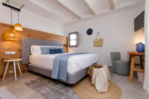a bedroom with a bed and a desk and a chair at La Serena Boutique Hotel & Wellness - Altea in Altea +37 photos