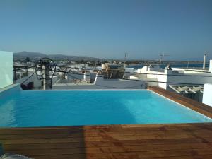 
a large swimming pool with a balcony overlooking the ocean at Majestique of Naxos in Naxos Chora
